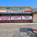 Large vinyl signs announce the closing of Trendy Department Store in Vista, which will remain open through the end of the year. Photo by Jim Trageser