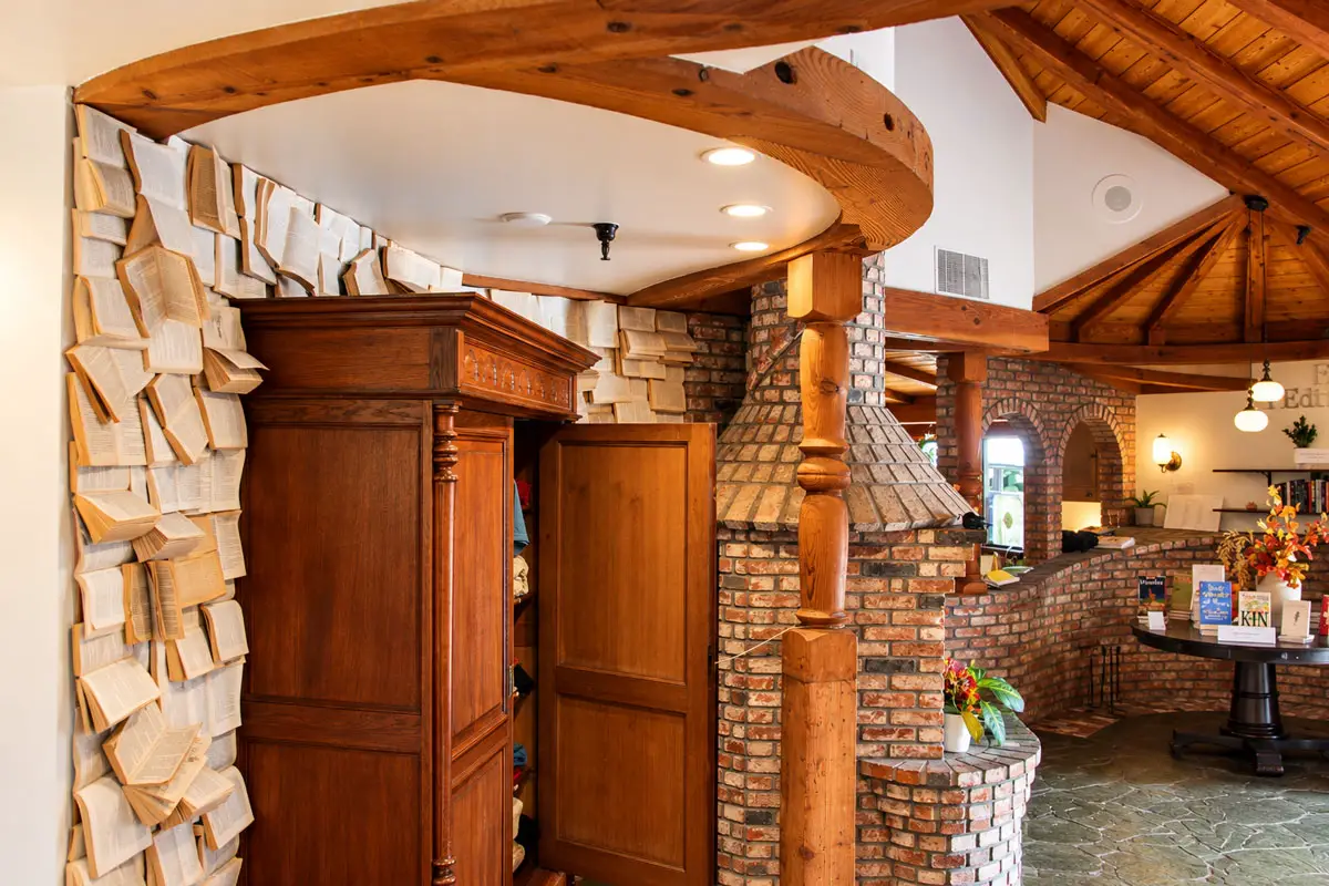 Open books adorn a wall at Carlsbad Village Books, where exposed wooden beams, rustic brickwork and other architectural details from a former Irish pub create a cozy, old-world atmosphere for book lovers. Photo by Christopher Bacon