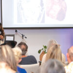 Pratiksha Gandhi, MD, addresses attendees during a previous health education gathering. Her Feb. 27 summit in Encinitas builds on three years of community events, workshops and retreats, with local businesses now invited to participate as sponsors and exhibitors. Courtesy photo