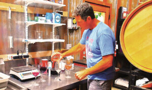 Hearst Ranch Winery winemaker Soren Christensen demonstrates how alcohol content in wine greatly influences the flavor and stability. The 2026 harvest started in mid-August, he said, because of the unusually warm, windy spring. Photo by Jerry Ondash