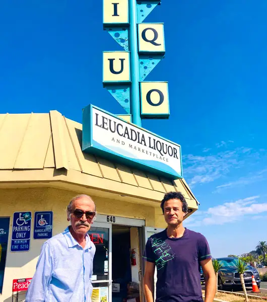 Kamil Mansoor, left, who bought the store in 1992, and longtime employee Tony stand outside Leucadia Liquor on N. Coast Highway 101, which is closing at the end of the month after six decades. Photo by David Boylan