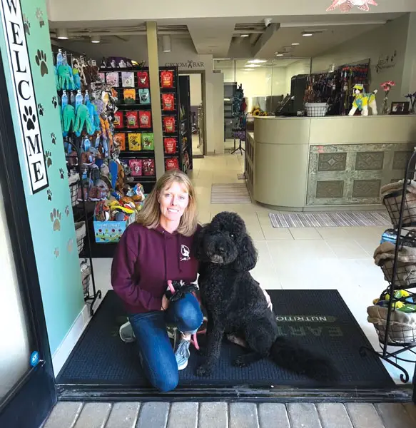 Earthwise Pet owner Leslie Hicks, a certified pet nutritionist, and her dog Duke at the store in Cardiff. Courtesy photo