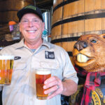 The author at Belching Beaver Pub 980 in Vista, holding examples of a Festbier, left, and a Märzen. Courtesy photo