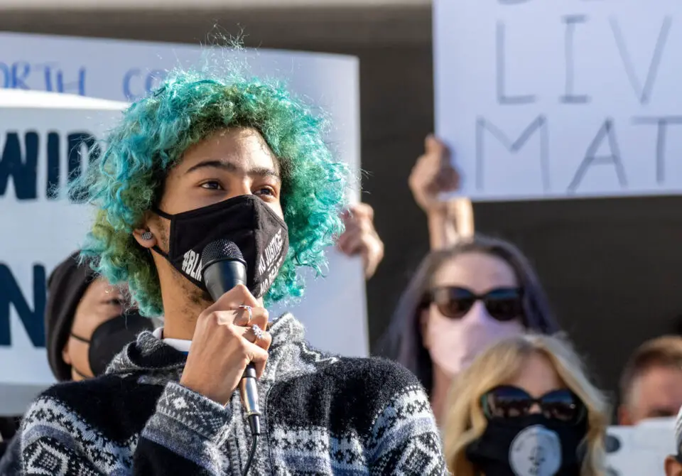 A student speaks during a rally Monday morning at San Dieguito Academy in response to racist and homophobic graffiti spray-painted on a school building.