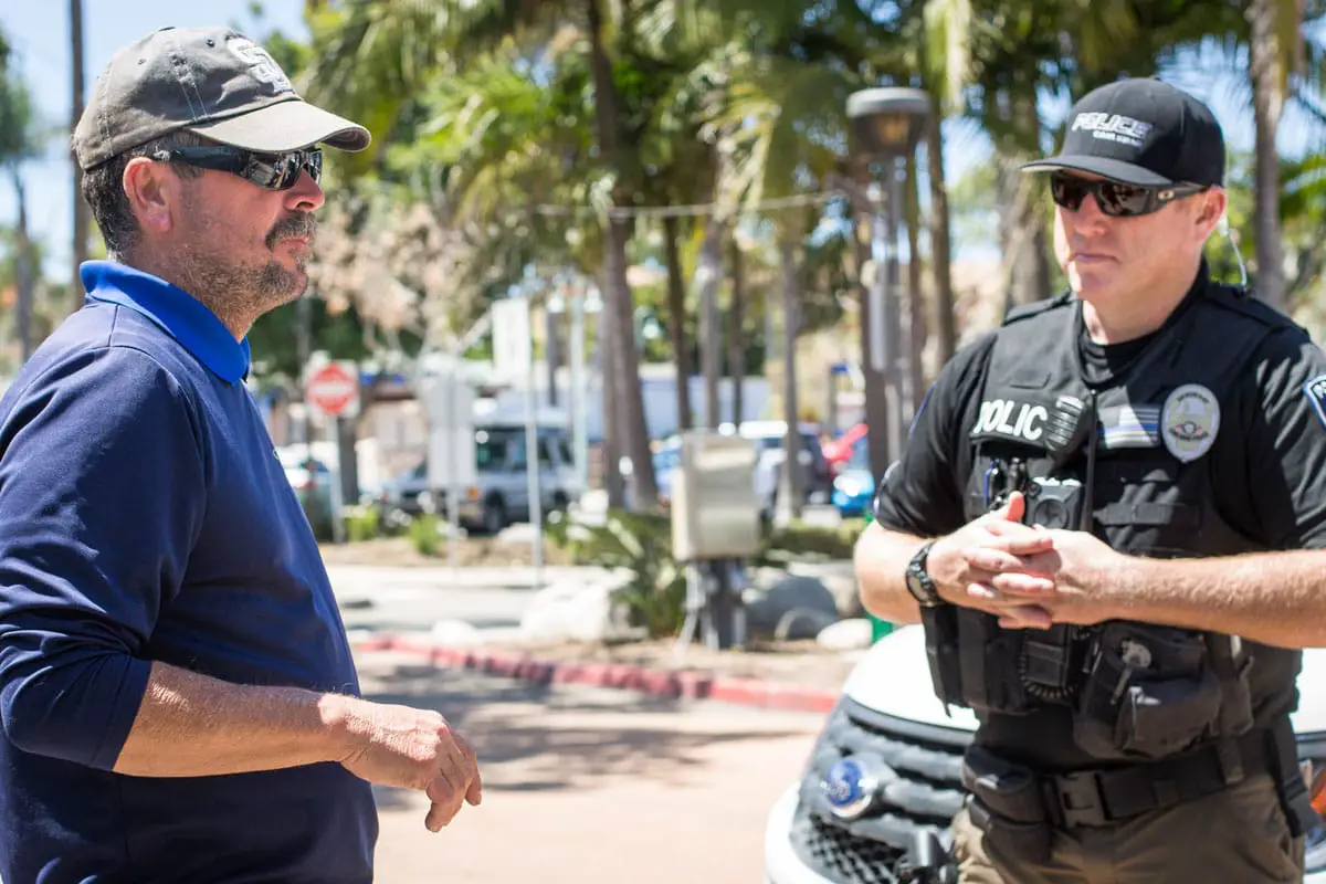 a member of Carlsbad Police Department’s Homeless Outreach Team (HOT) speaks with a homeless resident in 2018. Staff photo