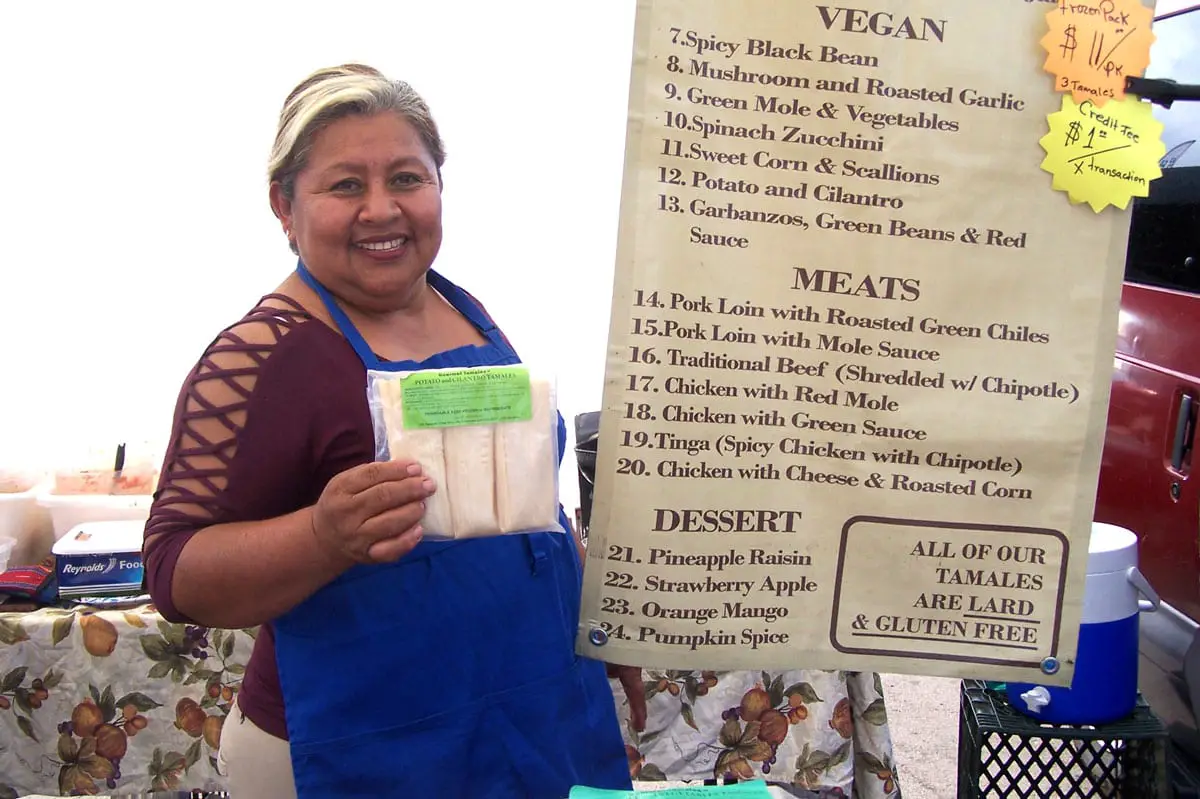 Leticia Manuel of Gourmet Tamales proudly displays her 25 varieties of homemade tamales at Vista Farmers' Market Photo by Jano Nightingale