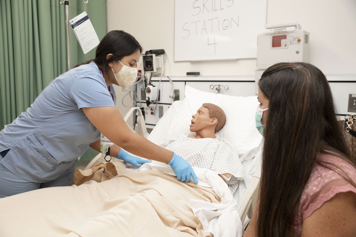 CSUSM nursing students work with a manikin in the simulation lab. The university has received a $200,000 gift to improve its existing nursing technology and equipment. Photo by Andrew Reed