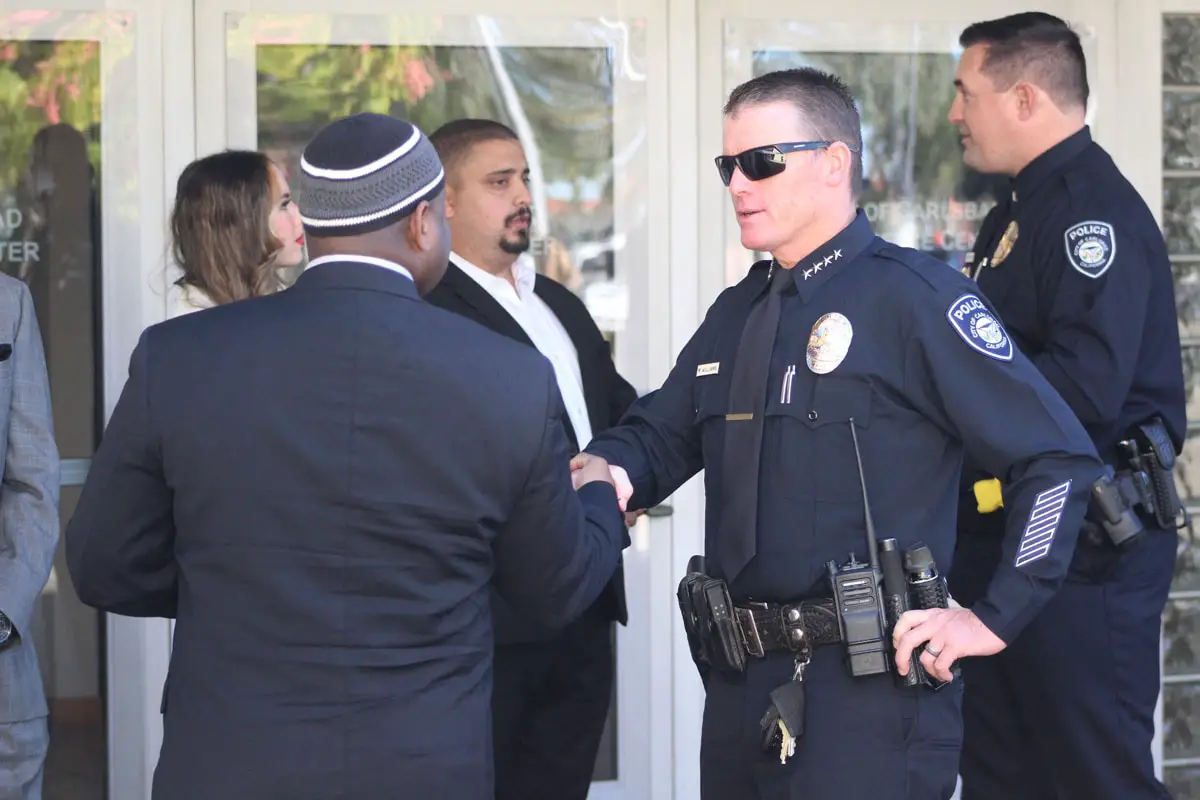 Carlsbad Police Chief Mickey Williams, right, shakes hands with Yusef Miller of the North County Equity and Justice Coalition after a press conference on Oct. 28 announcing the department’s new de-escalation policy. Photo by Steve Puterski