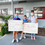 Families and advocates for The Winston School hold signs during a "Meet the Mayor" event on Aug. 30 in Del Mar. Courtesy photo