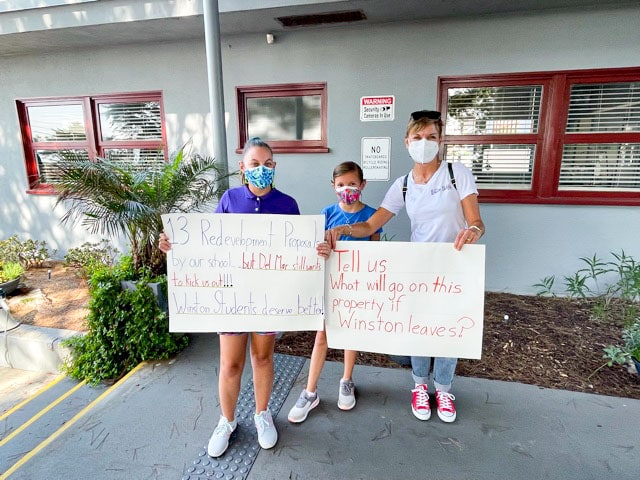 Families and advocates for The Winston School hold signs during a "Meet the Mayor" event on Aug. 30 in Del Mar. Courtesy photo