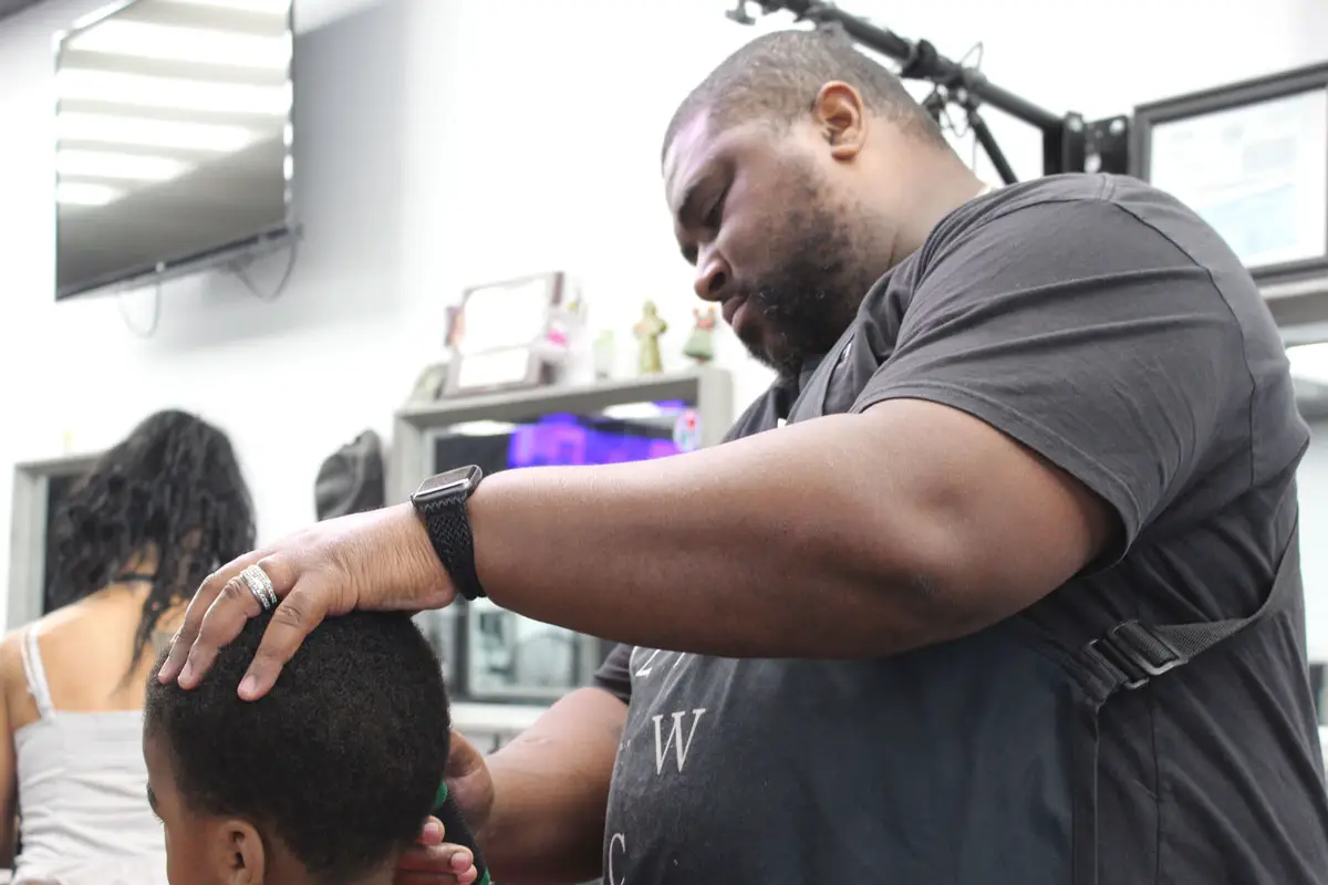 East 2 West Cutz manager and barber Jarred Powell and other barbers, cosmetologists, estheticians and manicurists are worried Senate Bill 803 will reduce the amount of professional education and training required in their fields.