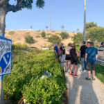 Residents who live in communities near Ocean Ranch industrial park in Oceanside gather in front of the proposed Amazon distribution center site on Ocean Ranch Boulevard on July 23.