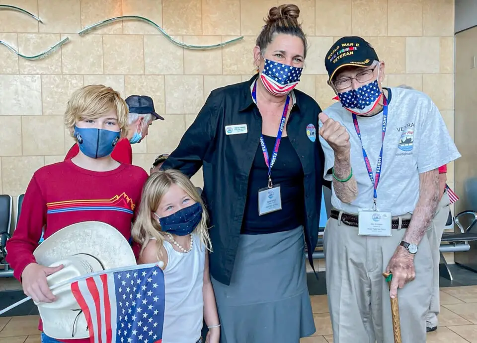 Rowe School students and siblings Jake and Ivy Hauenstein and teacher Stacey Halboth stand next to WWII veteran Dick Erickson, of Fallbrook.