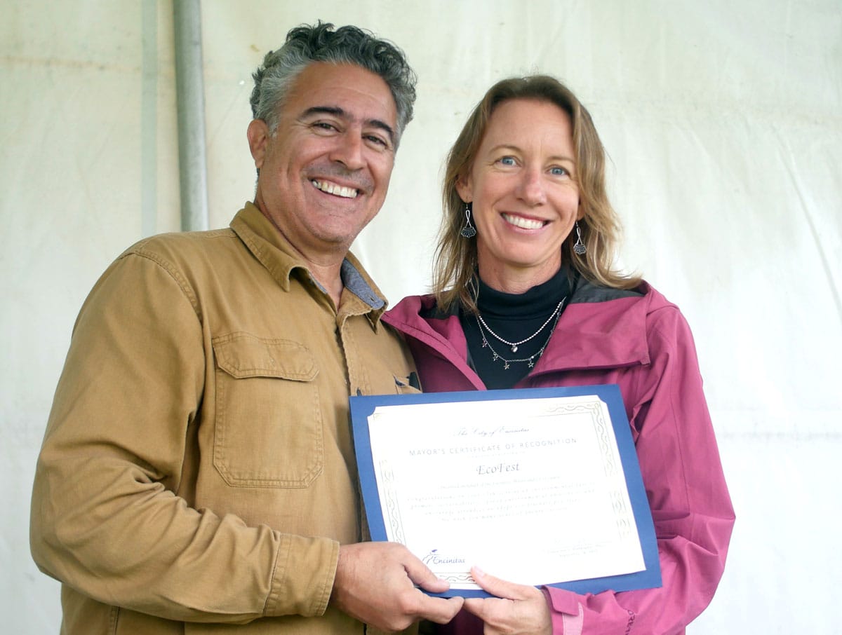 Mayor Catherine Blakespear presents a Certificate of recognition to John Gjata, chairman of EcoFest Encinitas. Photo by Dave Warren/DB Creative Media